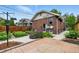 Backyard featuring a brick paver patio, garden beds, wooden fence, and the back of a brick home with windows at 3611 N Vine St, Denver, CO 80205