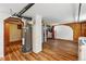Spacious basement area with wood-look flooring, exposed pipes, brick accents, and access to other rooms, including the laundry at 3611 N Vine St, Denver, CO 80205
