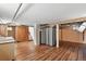 Unfinished basement with exposed ductwork, wood-look floors, and access to stairs at 3611 N Vine St, Denver, CO 80205