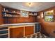 Basement area featuring pegboard walls with shelving and cabinet and drawer storage at 3611 N Vine St, Denver, CO 80205