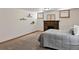 Basement bedroom with carpet, exposed brick fireplace, and wall shelves with plant decor at 3611 N Vine St, Denver, CO 80205