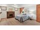 Basement bedroom featuring a brick fireplace, carpeted floors, and decorative wall art at 3611 N Vine St, Denver, CO 80205