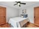 Bedroom features hardwood floors, a decorative ceiling fan, and neutral walls and trim at 3611 N Vine St, Denver, CO 80205