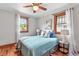 Bright bedroom with hardwood floors, two windows, and light blue accents at 3611 N Vine St, Denver, CO 80205