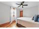 Cozy bedroom features hardwood floors, a ceiling fan, and a window with natural light at 3611 N Vine St, Denver, CO 80205