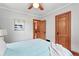 Bright bedroom featuring wood floors, neutral gray walls, and a door to another room at 3611 N Vine St, Denver, CO 80205