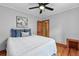Bedroom showcasing hardwood floors, a decorative ceiling fan, and ensuite access at 3611 N Vine St, Denver, CO 80205