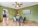Bright dining room features hardwood floors, a glass table, and a decorative ceiling fan at 3611 N Vine St, Denver, CO 80205