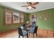 Stylish dining room with green walls and hardwood floors, connected to the living area at 3611 N Vine St, Denver, CO 80205