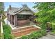 Charming brick home with a well-manicured front yard, garden beds, and inviting entry, great for curb appeal at 3611 N Vine St, Denver, CO 80205