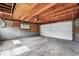 Unfinished garage with concrete floor and cinder block walls and exposed wood ceiling at 3611 N Vine St, Denver, CO 80205
