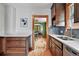 Kitchen with hardwood floors, stainless steel sink, dark cabinets, and view of dining room at 3611 N Vine St, Denver, CO 80205