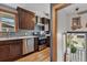 Kitchen with stainless steel appliances, dark cabinets, hardwood floors, and exterior entrance at 3611 N Vine St, Denver, CO 80205