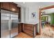 Spacious kitchen featuring stainless steel refrigerator, hardwood floors, and dark cabinets at 3611 N Vine St, Denver, CO 80205