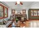 Cozy living room with a brick fireplace, hardwood floors, and natural light from the windows at 3611 N Vine St, Denver, CO 80205