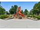 Colorful playground with slides, climbing structures, and soft landing areas, perfect for Gathering fun and recreation at 3611 N Vine St, Denver, CO 80205
