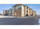 Side view of apartment building highlighting its multi-level design and parking area at 15345 W 64Th Ln # 304, Arvada, CO 80007