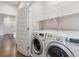 Laundry room with washer, dryer, and shelving at 15345 W 64Th Ln # 304, Arvada, CO 80007