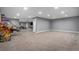 Large basement area with carpet and recessed lighting, adjacent to a seating area with a tv for entertainment at 2906 E 163Rd Ave, Thornton, CO 80602