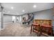 Finished basement featuring a sports game, bar with stools, and versatile space for entertainment and relaxation at 2906 E 163Rd Ave, Thornton, CO 80602