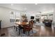 Bright dining area featuring a wooden table with bench seating, a view into the living room and a hutch at 2906 E 163Rd Ave, Thornton, CO 80602