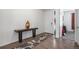 Inviting entryway with dark wood floors, console table with a gold vase, and view into the living space at 2906 E 163Rd Ave, Thornton, CO 80602