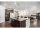 Open kitchen with island flows into dining area with hardwood floors and natural light at 2906 E 163Rd Ave, Thornton, CO 80602