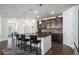 Modern kitchen with a dark wood cabinets, granite counters, and an island with barstool seating at 2906 E 163Rd Ave, Thornton, CO 80602