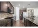 Well-appointed kitchen with modern appliances, dark cabinetry, and an expansive island at 2906 E 163Rd Ave, Thornton, CO 80602