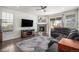 Cozy living room with a stone fireplace, media center, and large leather couch at 2906 E 163Rd Ave, Thornton, CO 80602