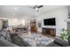 Spacious living room featuring hardwood floors, a ceiling fan, large windows, and comfortable leather seating at 2906 E 163Rd Ave, Thornton, CO 80602