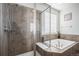 Luxurious main bathroom featuring a glass-enclosed shower and a soaking tub for ultimate relaxation at 2906 E 163Rd Ave, Thornton, CO 80602