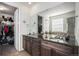 Elegant main bathroom with double sinks, granite counters, and direct access to a walk-in closet at 2906 E 163Rd Ave, Thornton, CO 80602