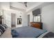 Comfortable main bedroom featuring a ceiling fan, TV, and a well-lit interior at 2906 E 163Rd Ave, Thornton, CO 80602