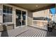 Covered patio area with sliding glass doors and outdoor seating at 2906 E 163Rd Ave, Thornton, CO 80602