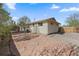 View of the home's backyard with a beautiful stone patio and mature trees at 11707 W 65Th Cir, Arvada, CO 80004