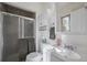 Well-lit bathroom featuring a shower with glass door and neutral wall colors at 11707 W 65Th Cir, Arvada, CO 80004