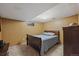 Basement bedroom with soft lighting, a comfortable bed, and classic dresser at 11707 W 65Th Cir, Arvada, CO 80004