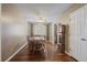 Inviting dining room with wood floors, a ceiling fan, and a view of the backyard at 11707 W 65Th Cir, Arvada, CO 80004
