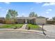 Charming brick home features a manicured front lawn and an attached two-car garage at 11707 W 65Th Cir, Arvada, CO 80004