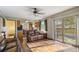 Open living space with hardwood floors, a sliding glass door, and view into kitchen at 11707 W 65Th Cir, Arvada, CO 80004