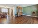 Open-concept living room with hardwood floors, view into dining room, and an elegant cabinet at 11707 W 65Th Cir, Arvada, CO 80004
