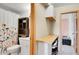 Bright bathroom featuring a floral shower curtain, under sink storage and a linen closet at 30273 Conifer Rd, Evergreen, CO 80439