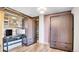 Bright bedroom with modern décor featuring dark wood floors, a desk, and wall-mounted closets at 30273 Conifer Rd, Evergreen, CO 80439