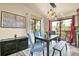 Bright dining room with large windows, stylish light fixture, and access to the outdoor deck at 30273 Conifer Rd, Evergreen, CO 80439