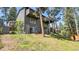 Rear exterior elevation featuring multiple decks, large windows, and access to the backyard at 30273 Conifer Rd, Evergreen, CO 80439
