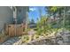 View of home exterior showing the deck, garden, gate, and yard at 30273 Conifer Rd, Evergreen, CO 80439