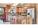 Updated kitchen with granite countertops, stainless steel appliances, custom cabinets, island, and open view to the exterior at 30273 Conifer Rd, Evergreen, CO 80439