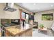 Open concept kitchen with granite countertops and connected living area at 30273 Conifer Rd, Evergreen, CO 80439