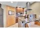 Kitchen with granite countertops, wooden cabinets, and modern stainless steel range hood at 30273 Conifer Rd, Evergreen, CO 80439